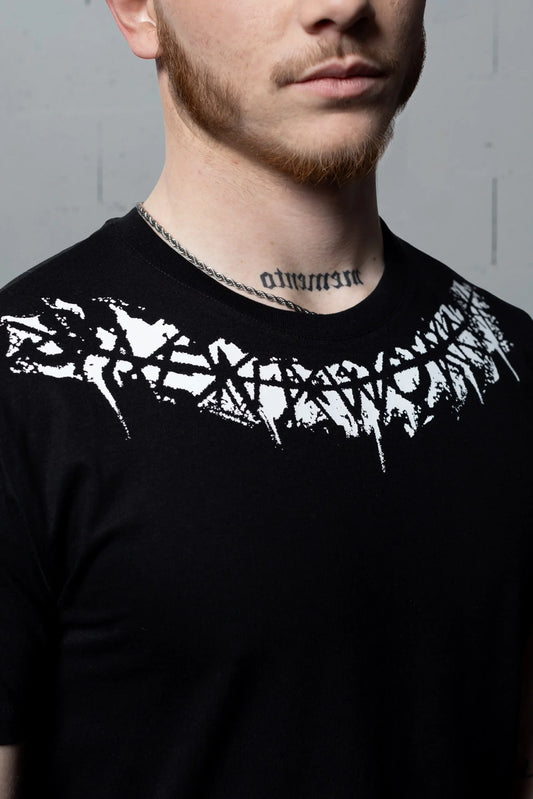 Close-up of a man wearing a Silent Worker black powerlifting t-shirt with bold white graphic print