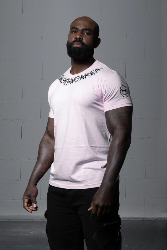 Muscular man modeling Silent Worker powerlifting shirt in studio, logo on collar and sleeve